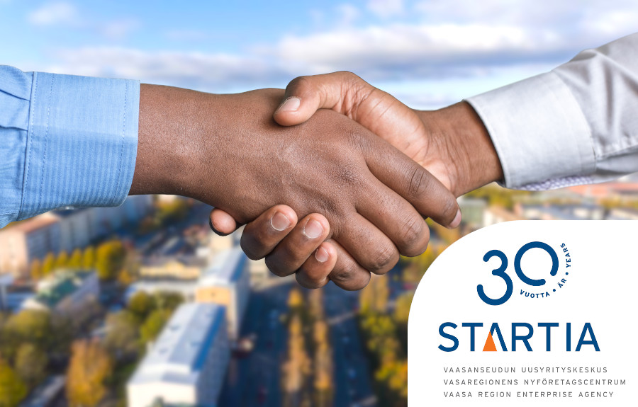 Handshake with City of Vaasa aerial in the background and the logo of Startia - Vaasa Region Enterprise Agency