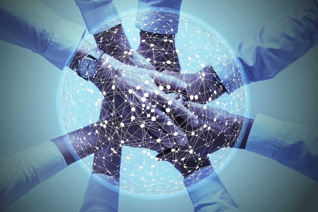 Connected hands overlayed with a global network