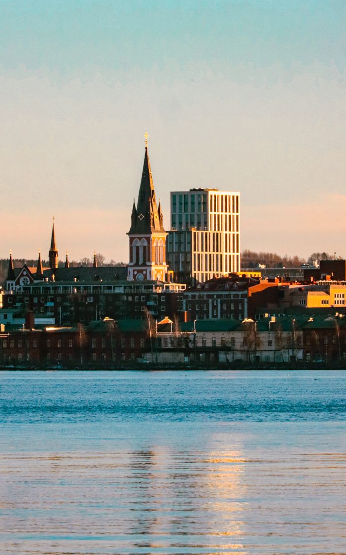 Cityscape of Jönköping, Sweden with waterfront and sunset glow.